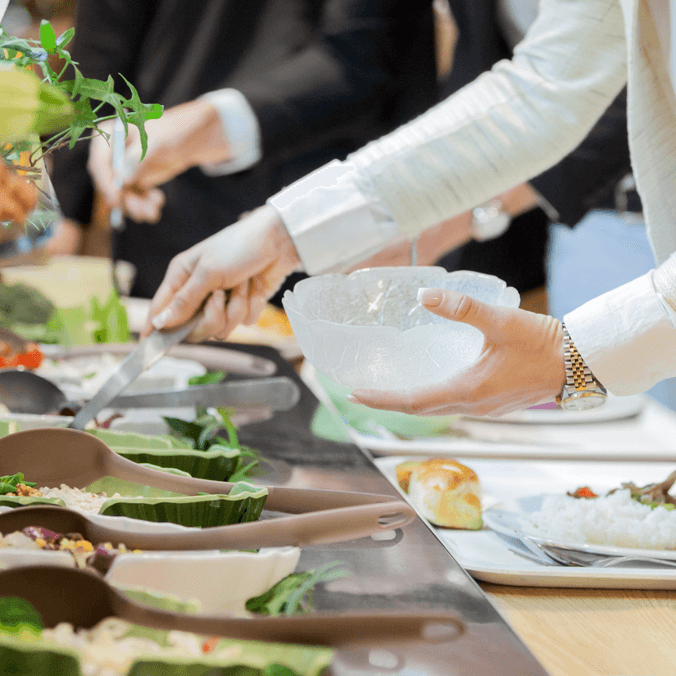 People serving themselves food & salads