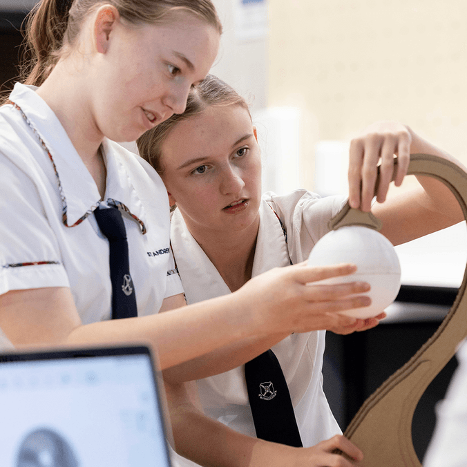 High school students interacting with sphere