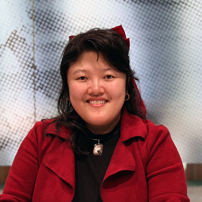 Woman in red jacket smiling at camera