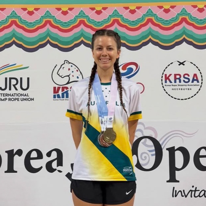 Student in athletic gear with medal