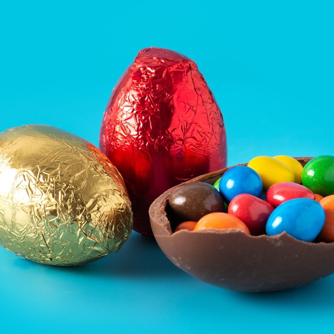 Blue background with easter eggs in coloured foil