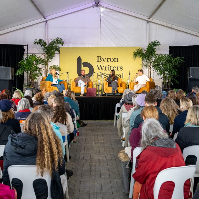 Crowd facing stage of panellists