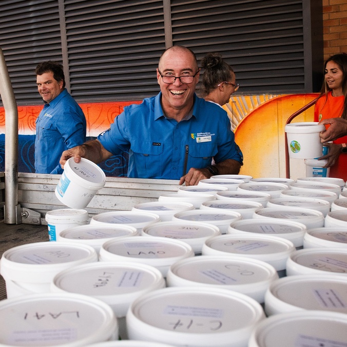 Person smiling in front of buckets