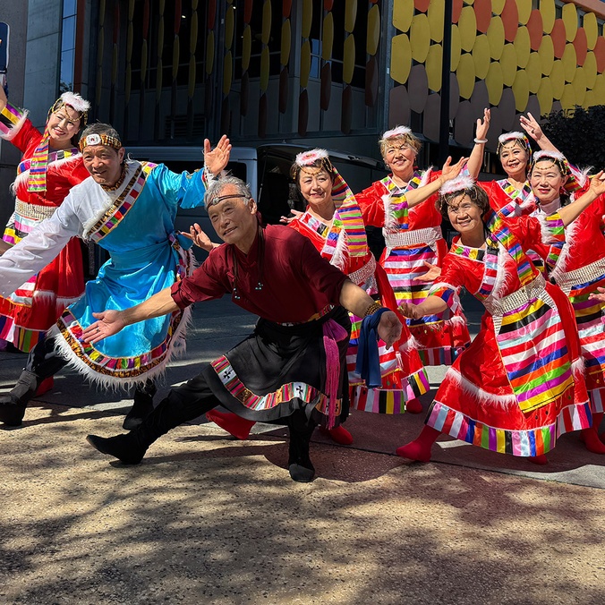 Group of people in brightly coloured traditional outfits