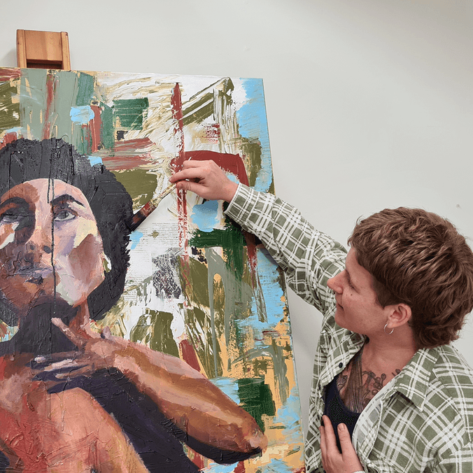 Student painting portrait of woman