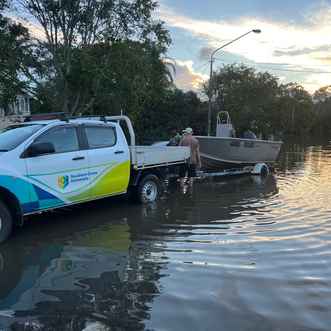 Professor Bradley Eyre loading the University research boat from Lismore flood waters