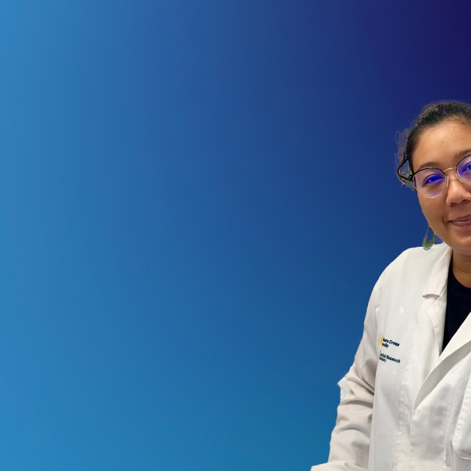 A scientist in a lab coat on a blue background