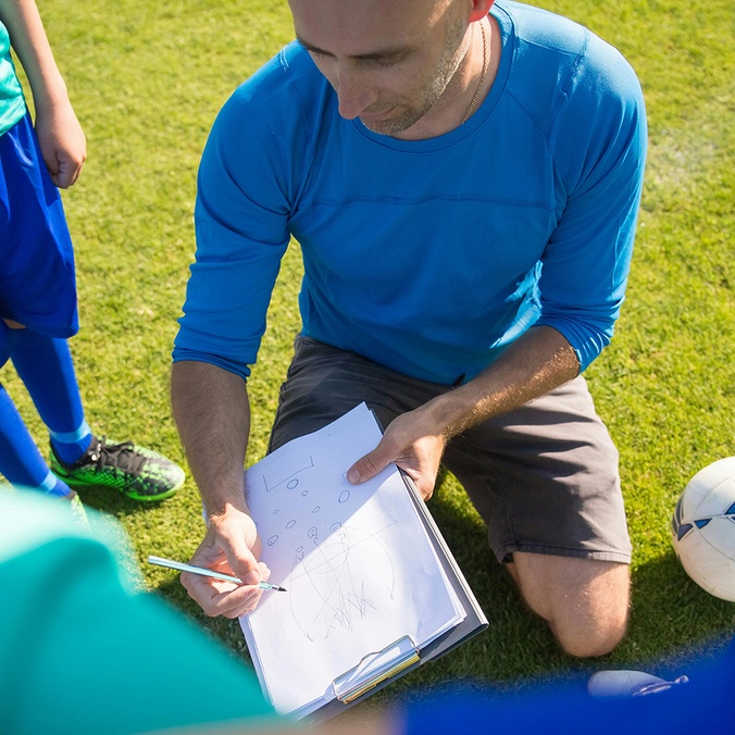 Sports coach with game plan