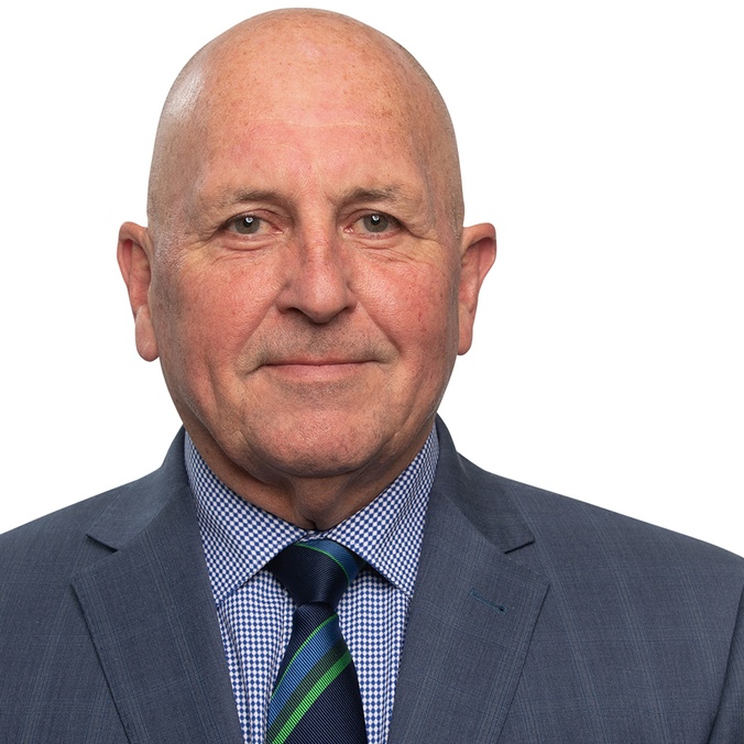 A bald-headed man in a suit and tie