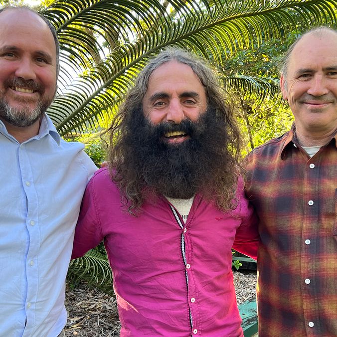 Three men in an outside garden