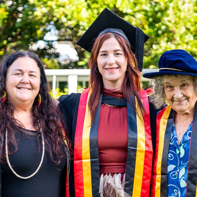 Three women in graduation robes