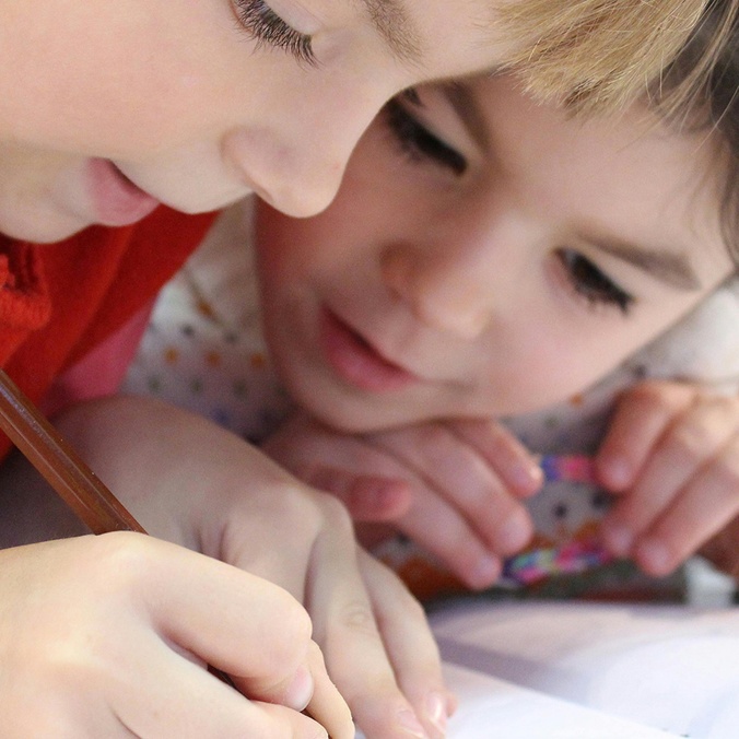 Two young girls drawing