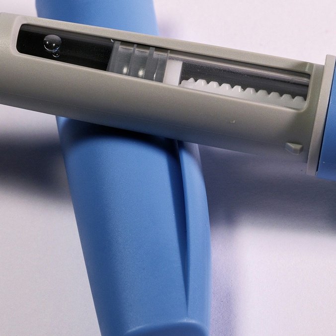 a-blue-and-white-medical-device-on-a-white-surface