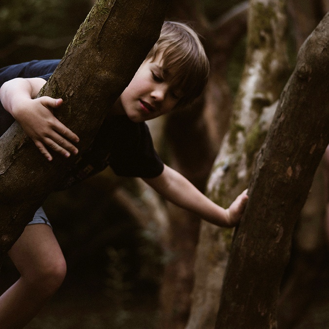 Boy and girl climbing up trees
