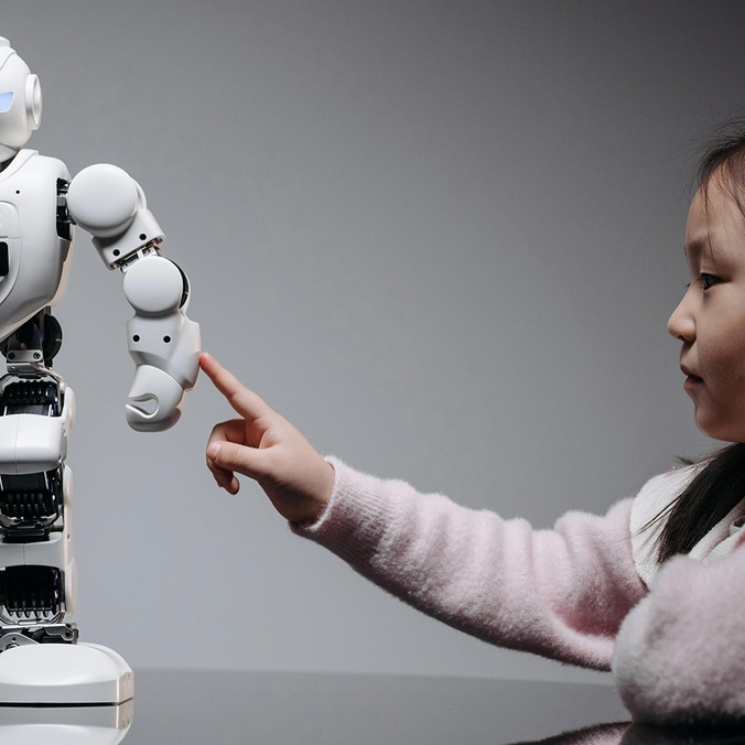 A young girl engaging with a robotic toy, highlighting curiosity and innovation