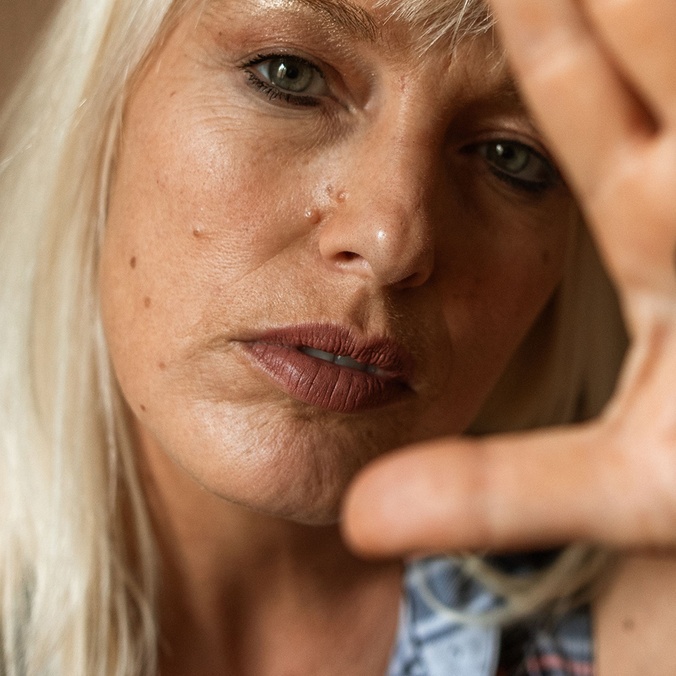 Blonde-haired woman with Quit written on her hand