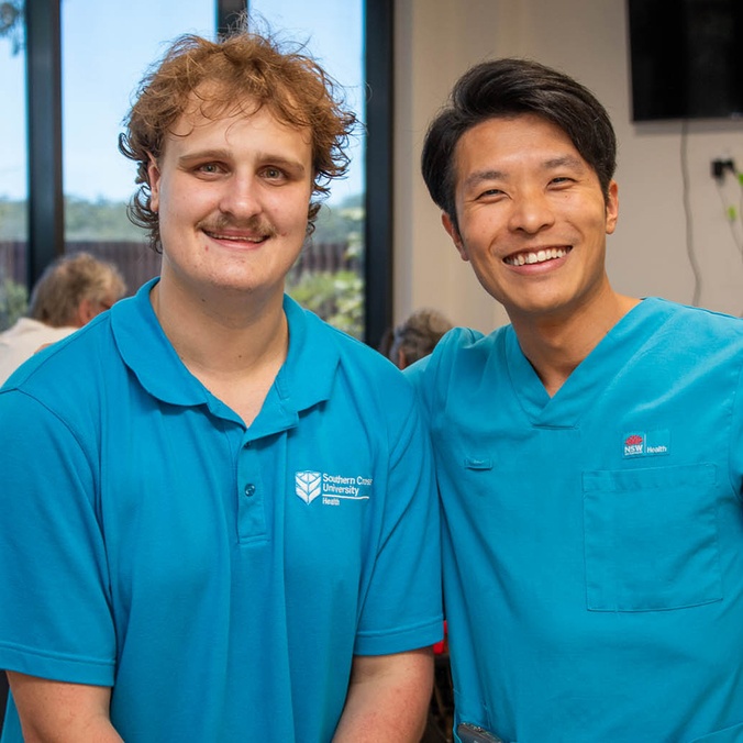 2 men in blue uniform shirts