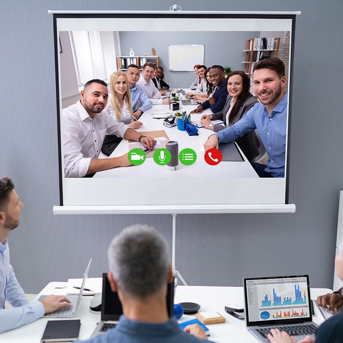 group of people meeting in person and online