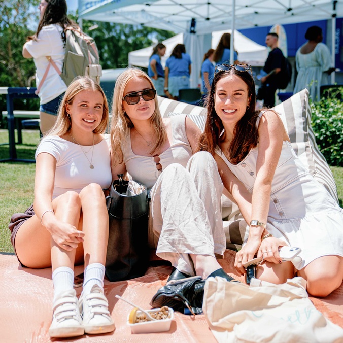 Student group sitting on grass
