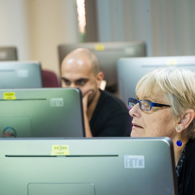 Two students sitting in front of computers