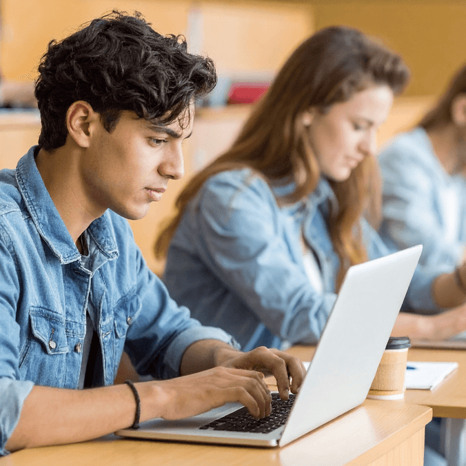 Students on laptops studying together