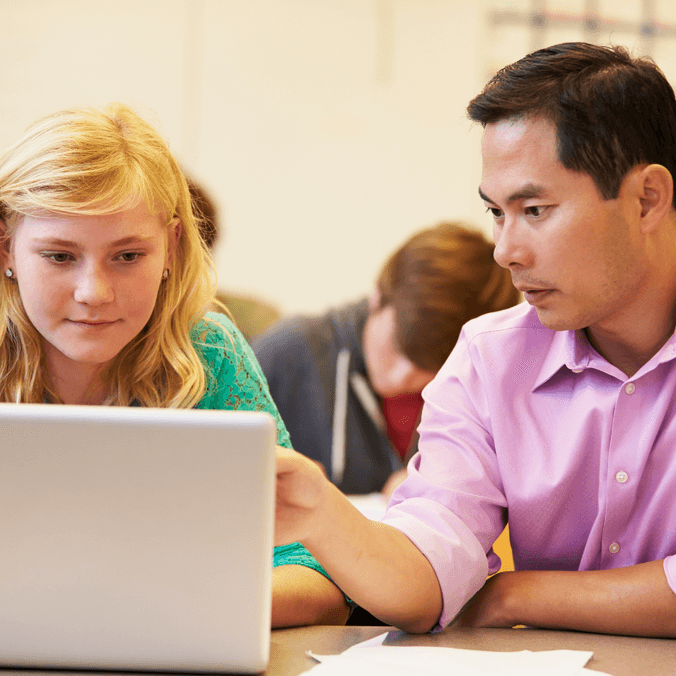 Two students on laptops studying, peer support, postgrad