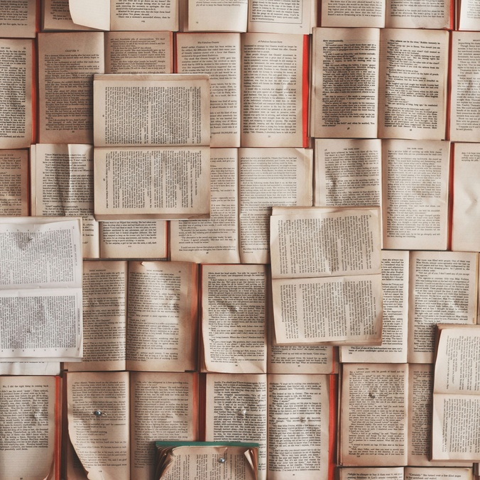Pages of books laid down in various landscapes
