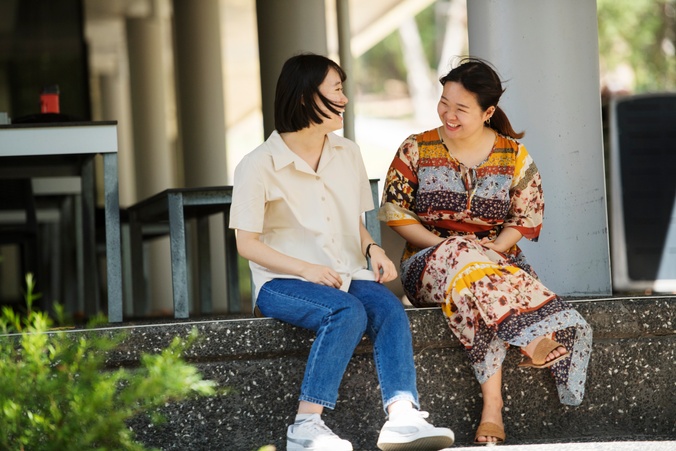 Two female students chatting at Lismore campus