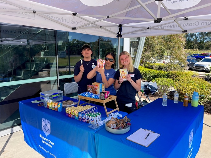 Three Vollies hand out freebies to students