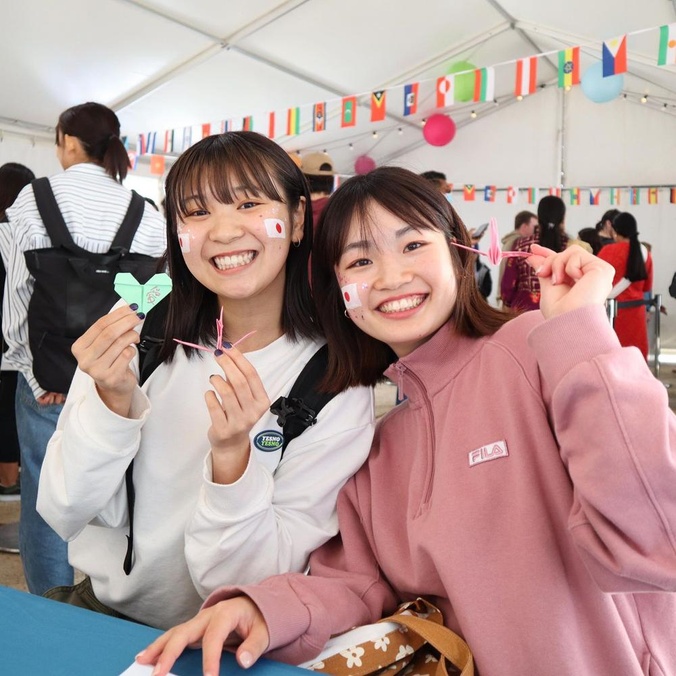 Two students with Japanese flags and origami