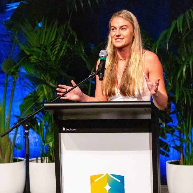 Student speaking at lectern