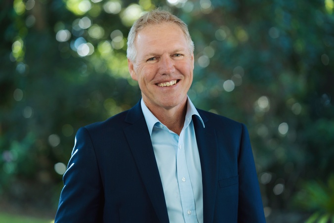 Kevin Franey smiling in a suit