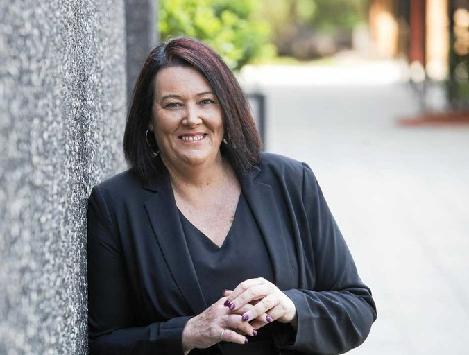 Johanna Byrne leaning against a wall smiling