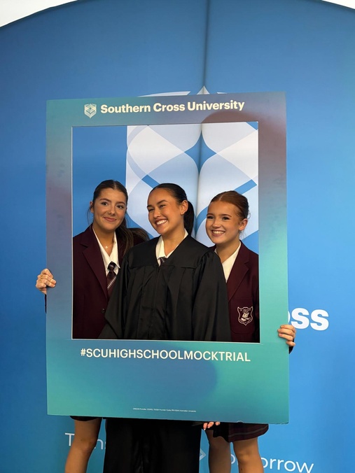 Students posing with social media frame at Mock Trial