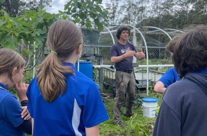 Simon Hartley with students in community garden