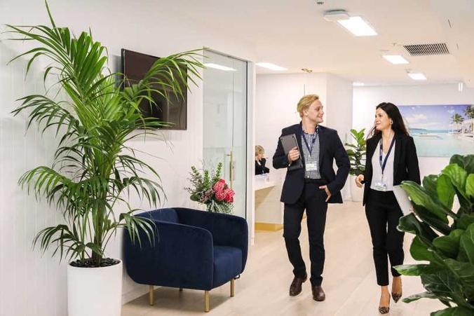 Two students walking through a hallway together