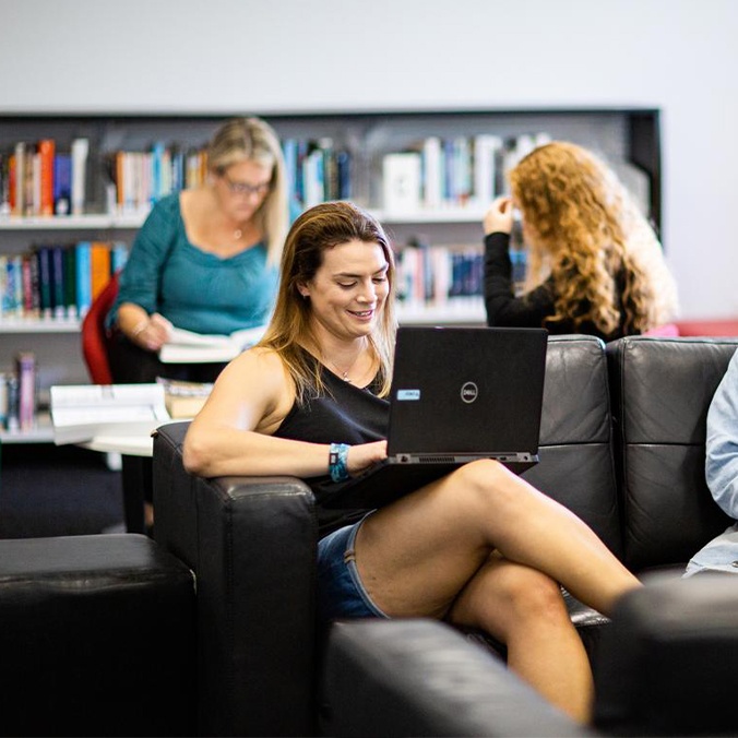 Female student using laptop