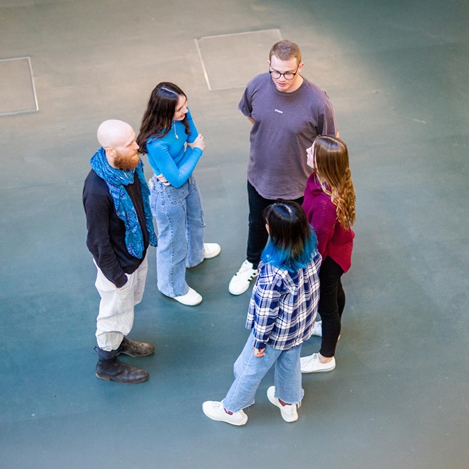 Group of students talking in a circle
