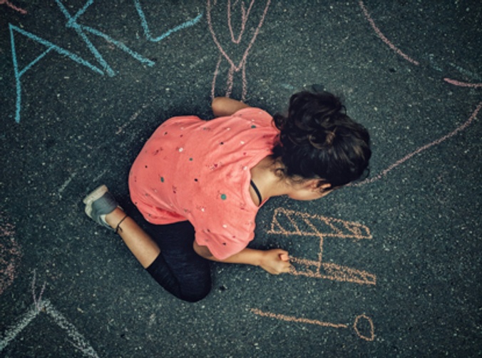 Child drawing on ground