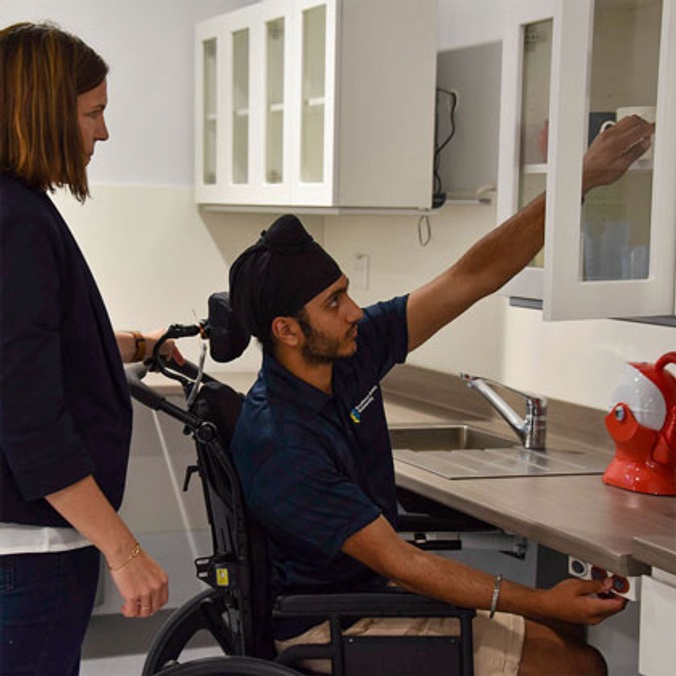 man in wheelchair accessing kitchen