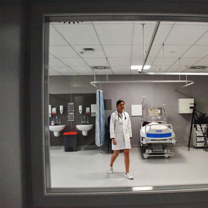 Female nurse student walking through health lab