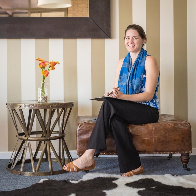 Woman sitting on a lounge chair beside a coffee table