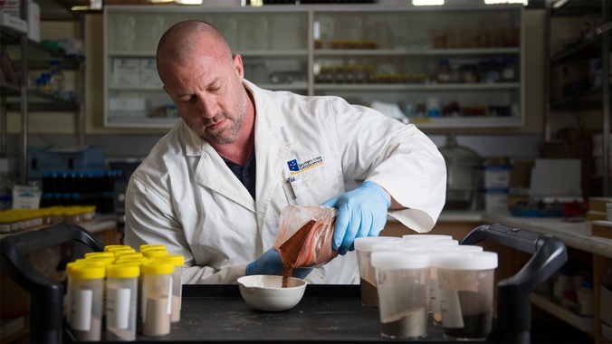 Professor Ed Burton working in lab with soil samples
