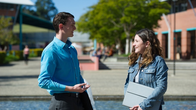 Male and female students talking at the Coffs Harbour campus