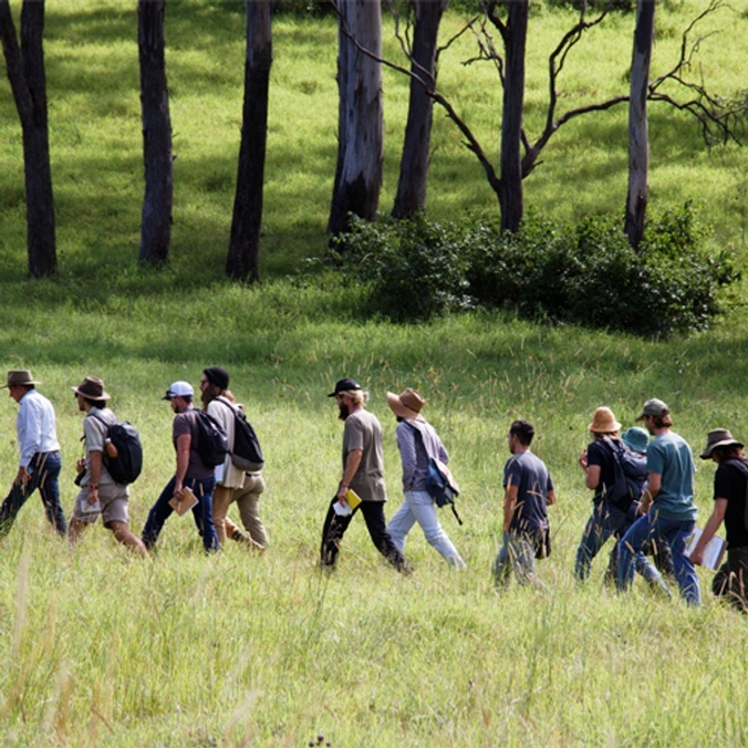 Students walk across a field