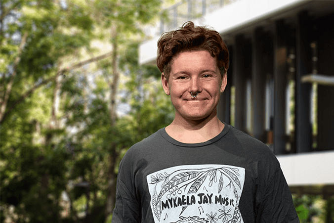 Student standing in front of learning centre at Lismore