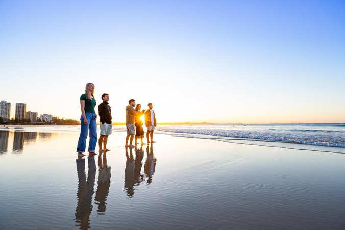 Students standing on the beach