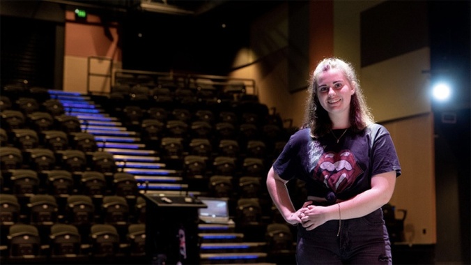 A student at Coomera campus stands in an empty theatre