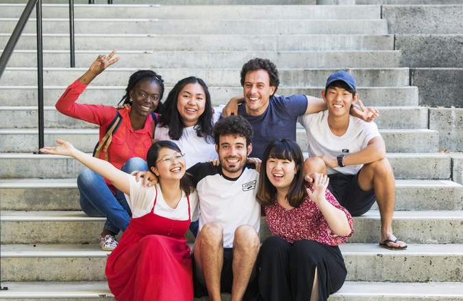 SCU College EAP students in a group smiling together on the stairs