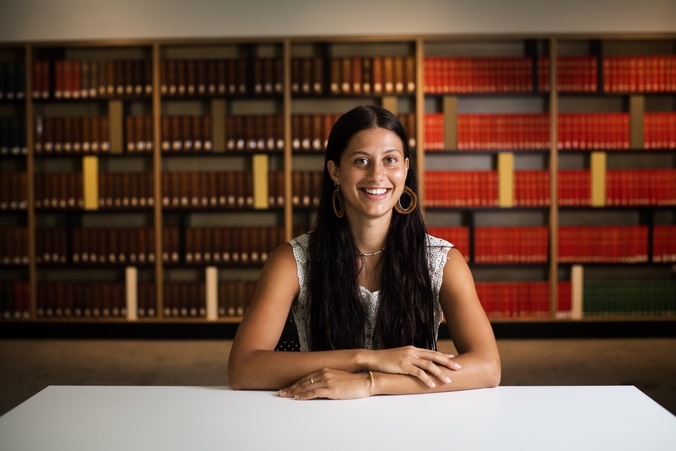 Student sitting in front of law books